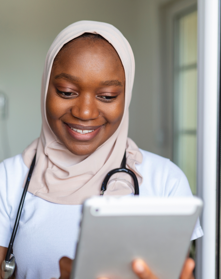 Healthcare professional reviewing notes on a tablet